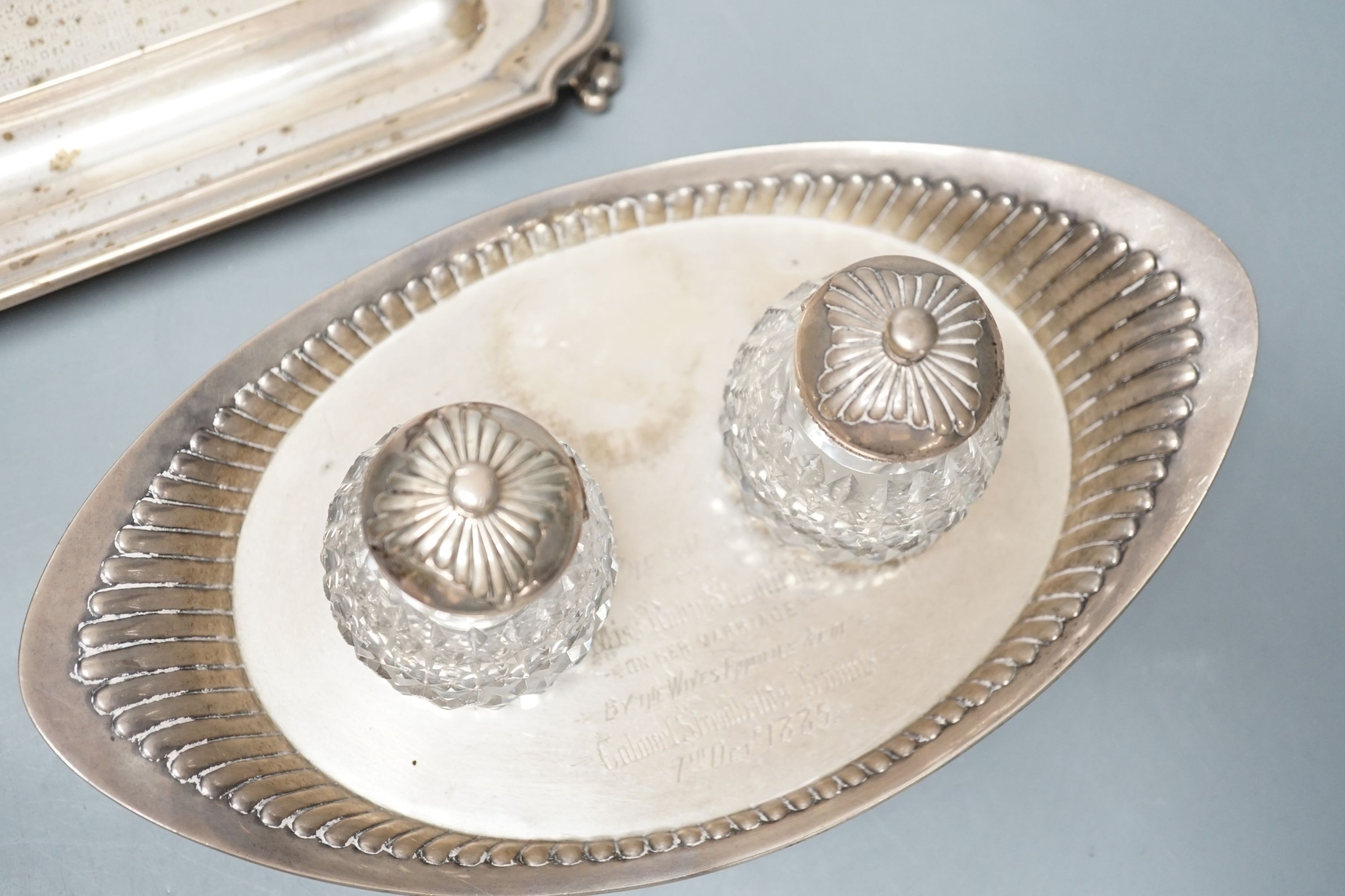 A presentation silver oval inkstand, with two mounted glass wells, William & John Barnard, London, 1884, ‘presented to Miss Ruby Streatfeild’, (a.f.),24.1cm and one other silver inkstand, Charles Stuart Harris, London, 1